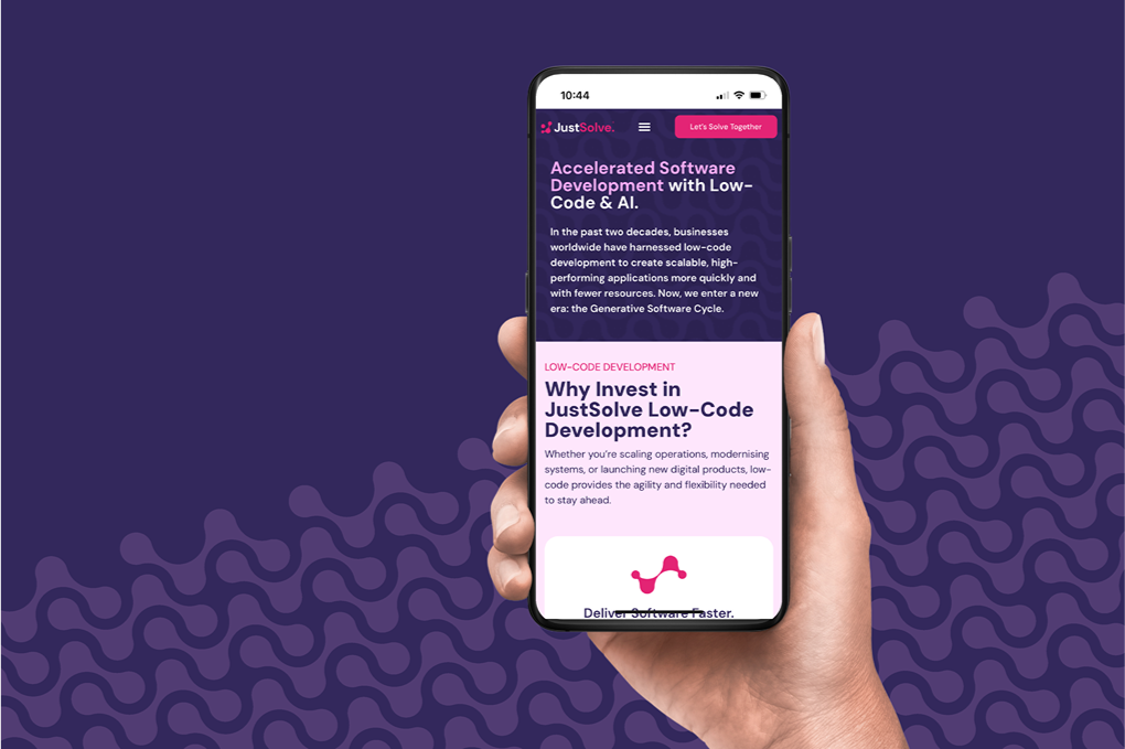 Person holding phone with JustSolve website mockup