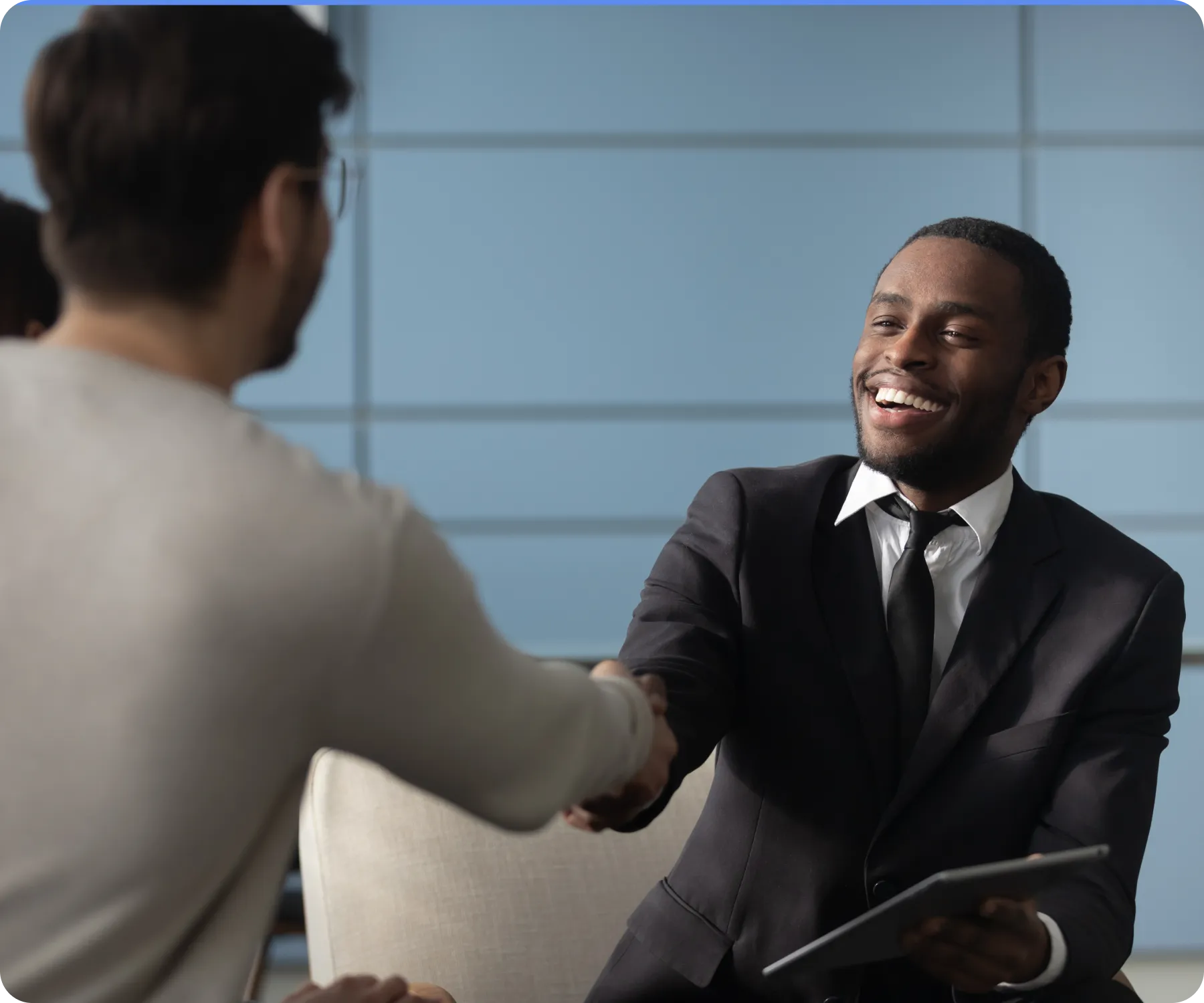 Two men happily shaking hands